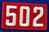 One Piece Unit Number 502 White on Red